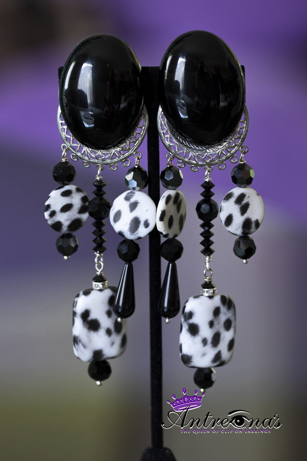 Long dangling black white cheetah clip on earrings.