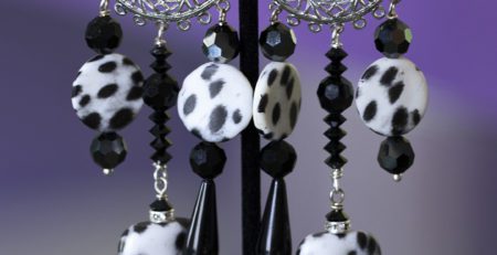 Long dangling black white cheetah clip on earrings.