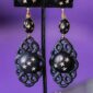 Astral Veil striking clip on earrings captures a celestial elegance through its striking use of black and gold