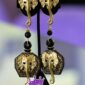 Trunked Majesty is a bold pair of clip-on earrings featuring detailed golden elephant heads with graceful trunks and decorative beads. Hexagonal black and gold patterns frame raised elephant motifs, blending luxury and strength in a regal, elegant design fit for a queen.