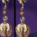 Golden Trunk Elegance is a pair of statement clip-on earrings that masterfully blend bold animal imagery with refined craftsmanship