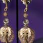 Golden Trunk Elegance is a pair of statement clip-on earrings that masterfully blend bold animal imagery with refined craftsmanship