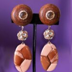 These clip-on earrings combine warm earthy tones with subtle sparkle, creating a quiet yet commanding presence.