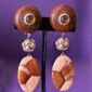These clip-on earrings combine warm earthy tones with subtle sparkle, creating a quiet yet commanding presence.
